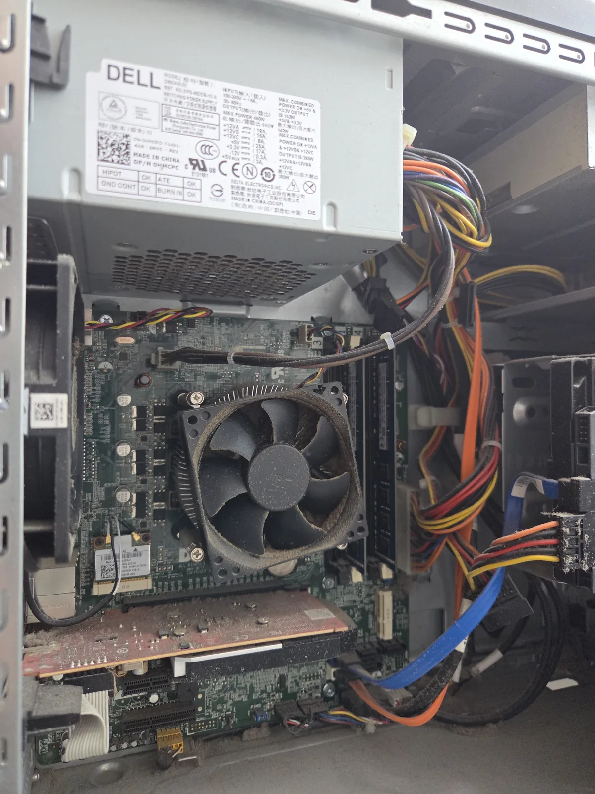 Dusty computer fan and heatsink before cleaning during an on-site visit
